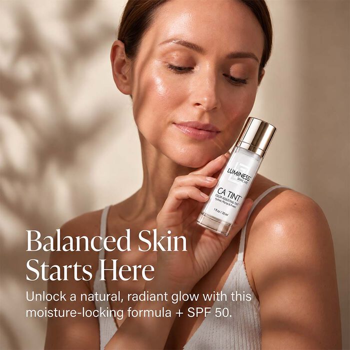 Woman applying LUMINESS CA Tint SPF 50 adaptive tinted moisturizer for a radiant complexion