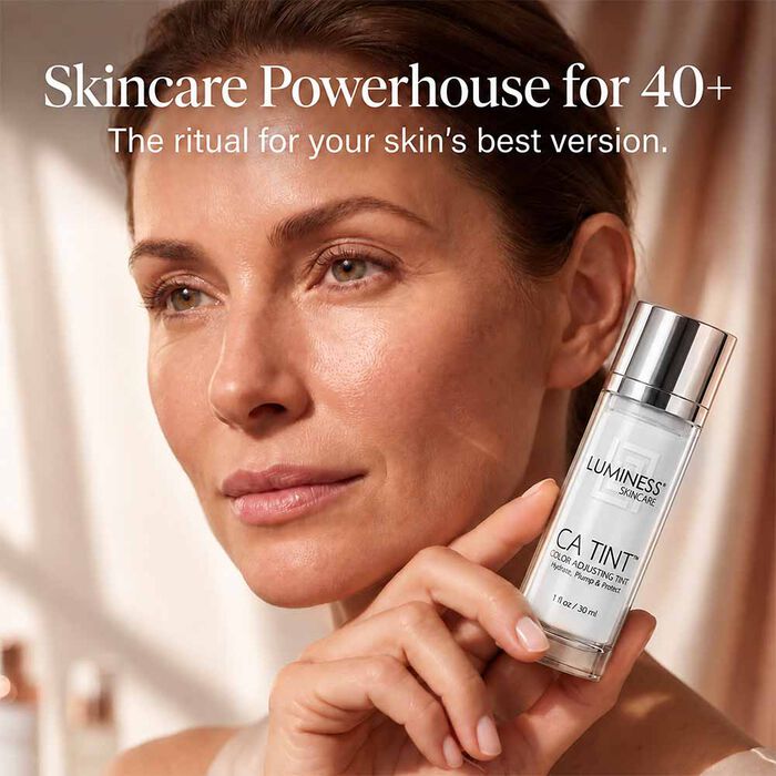 Woman over 40 holding LUMINESS CA Tint SPF 50 tinted moisturizer for everyday complexion coverage