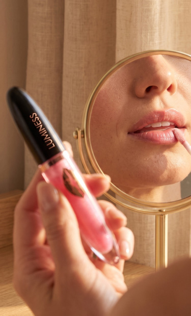 Luminess gentle lip booster application in front of a mirror